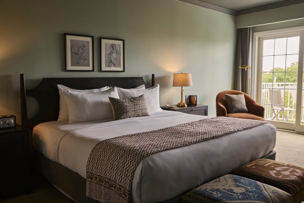 A king bed with a balcony at The Harbor Front Inn.