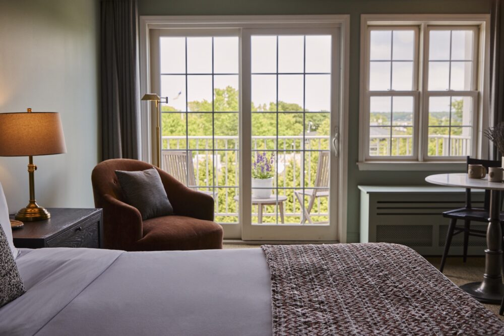 A king bed with a balcony at The Harbor Front Inn.