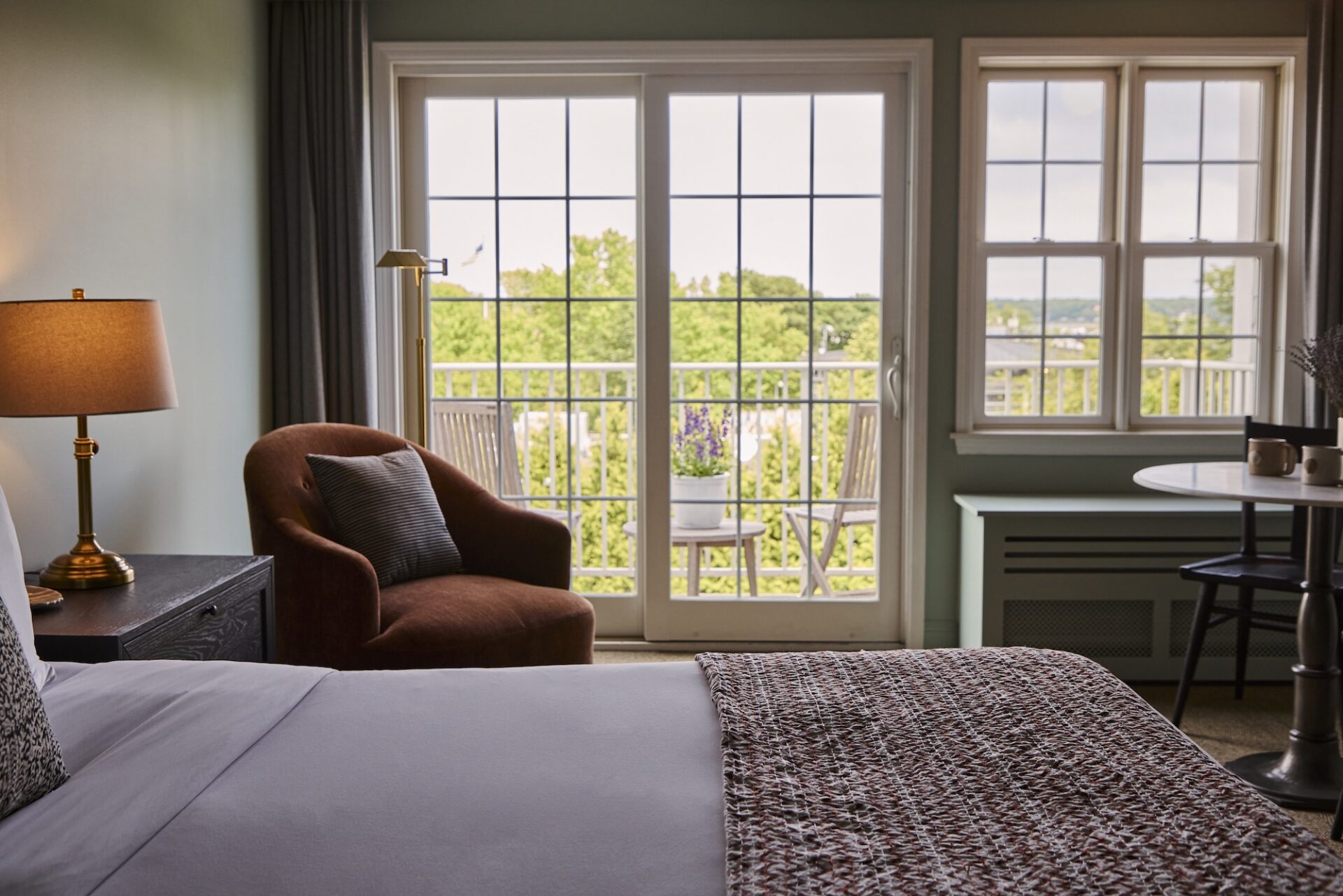 A king bed with a balcony at The Harbor Front Inn.