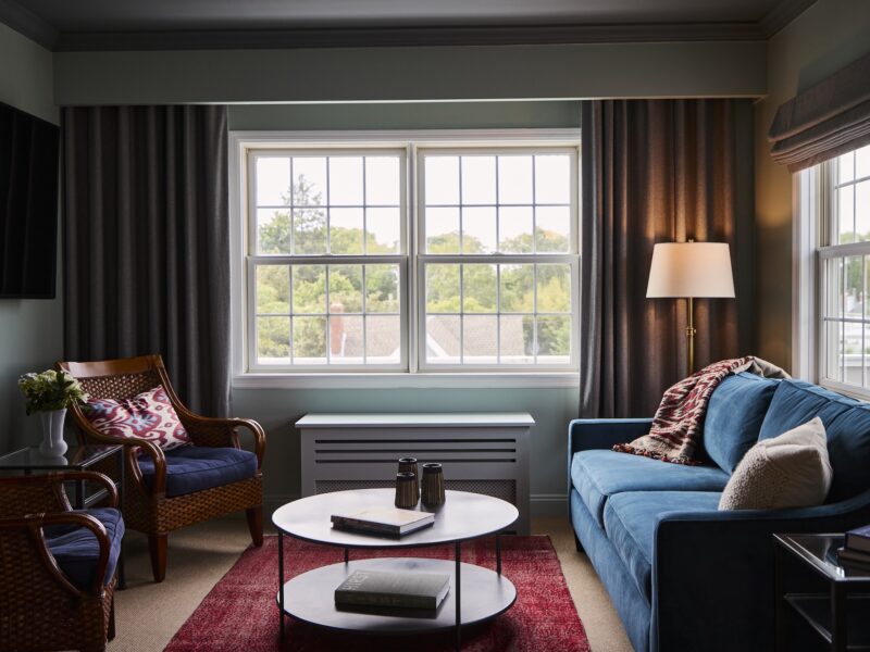 A seating area with a sofa and two chairs in the Terrace Suite at The Harbor Front Inn.
