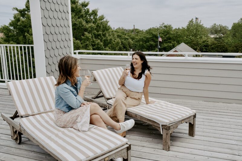 two women enjoying wine on the rooftop