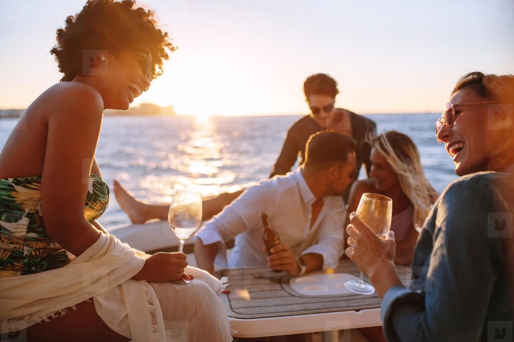 friends on boat at sunset