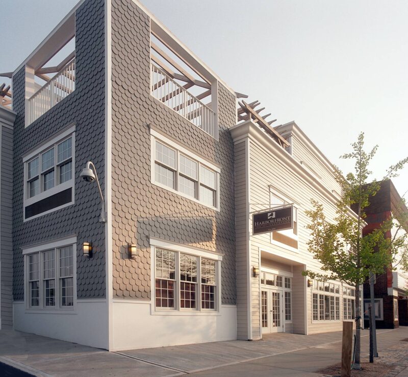The exterior of Harbor Front Inn at dusk.