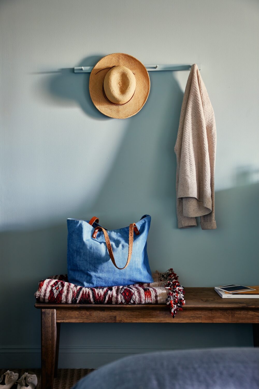 A cardigan, hat, and blue tote bag.