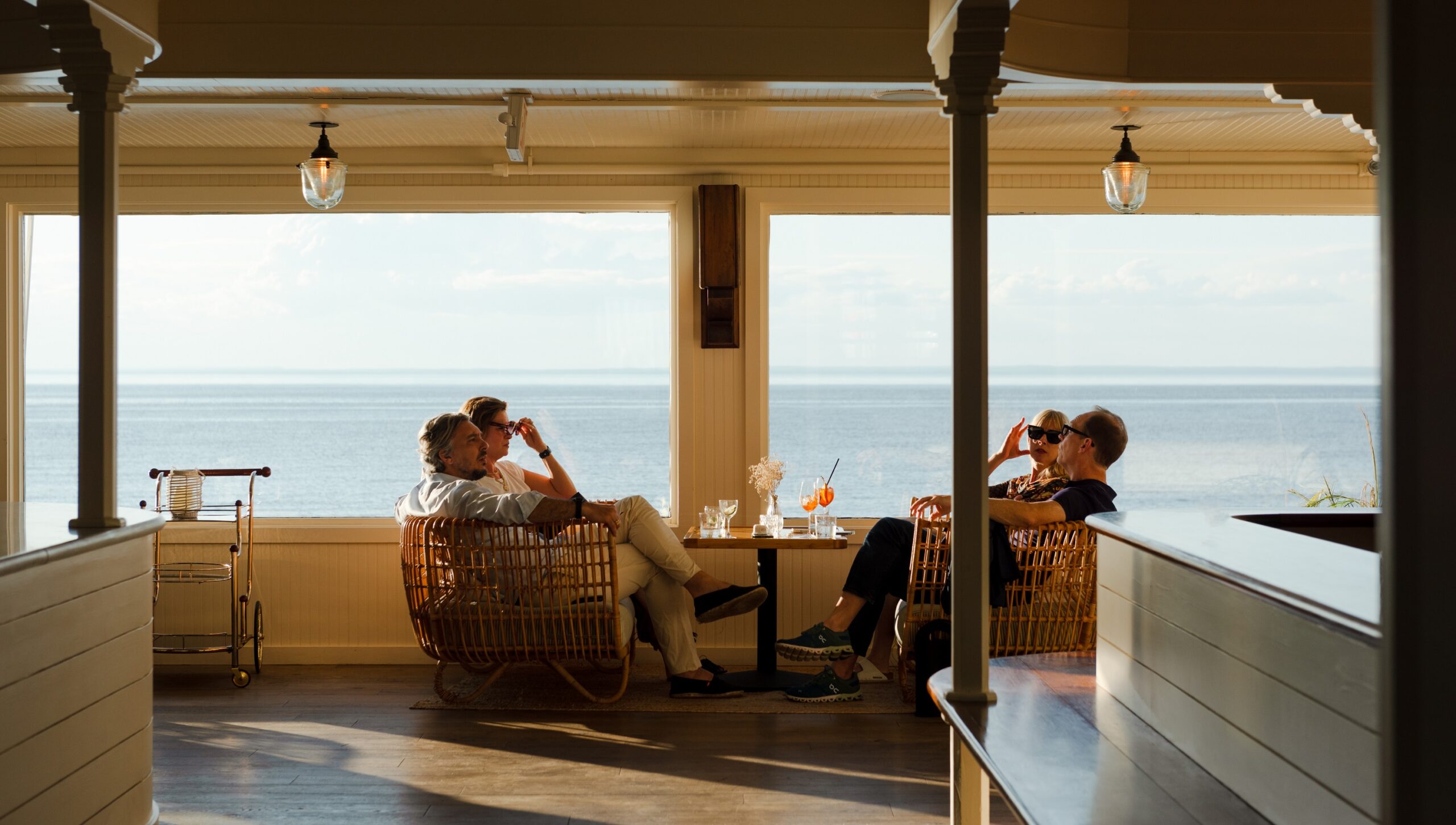 Couples sitting in a restaurant having wine and bites.