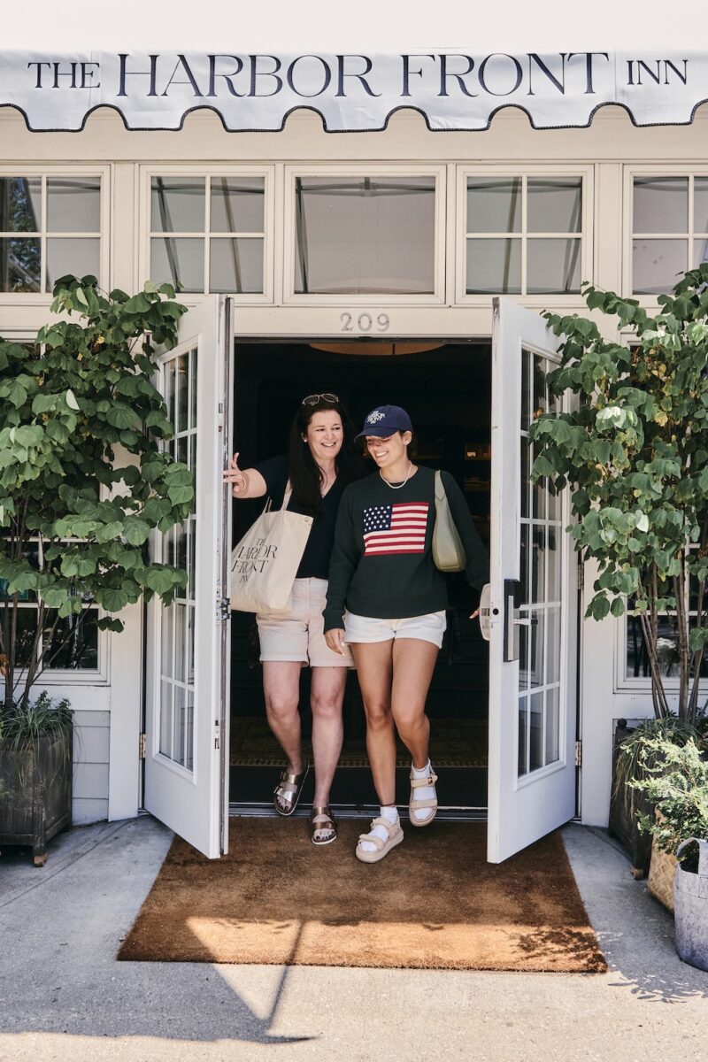 Two women walking out the door at Harbor Front Inn.