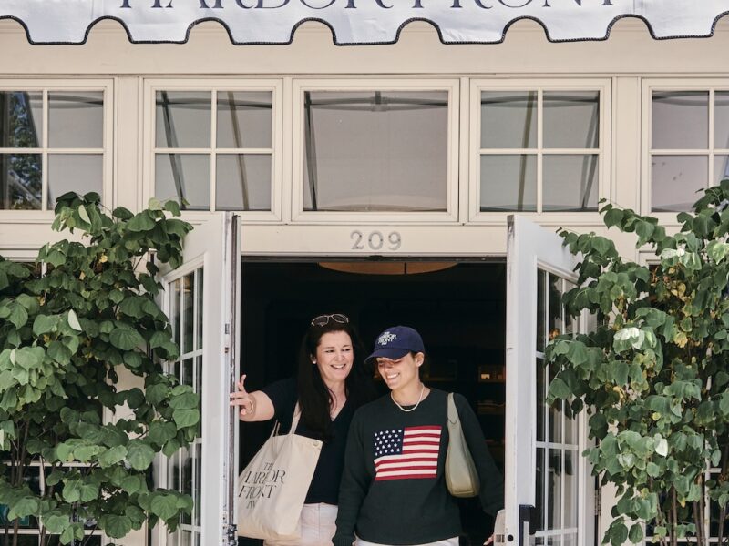 Two women walking out the door at Harbor Front Inn.