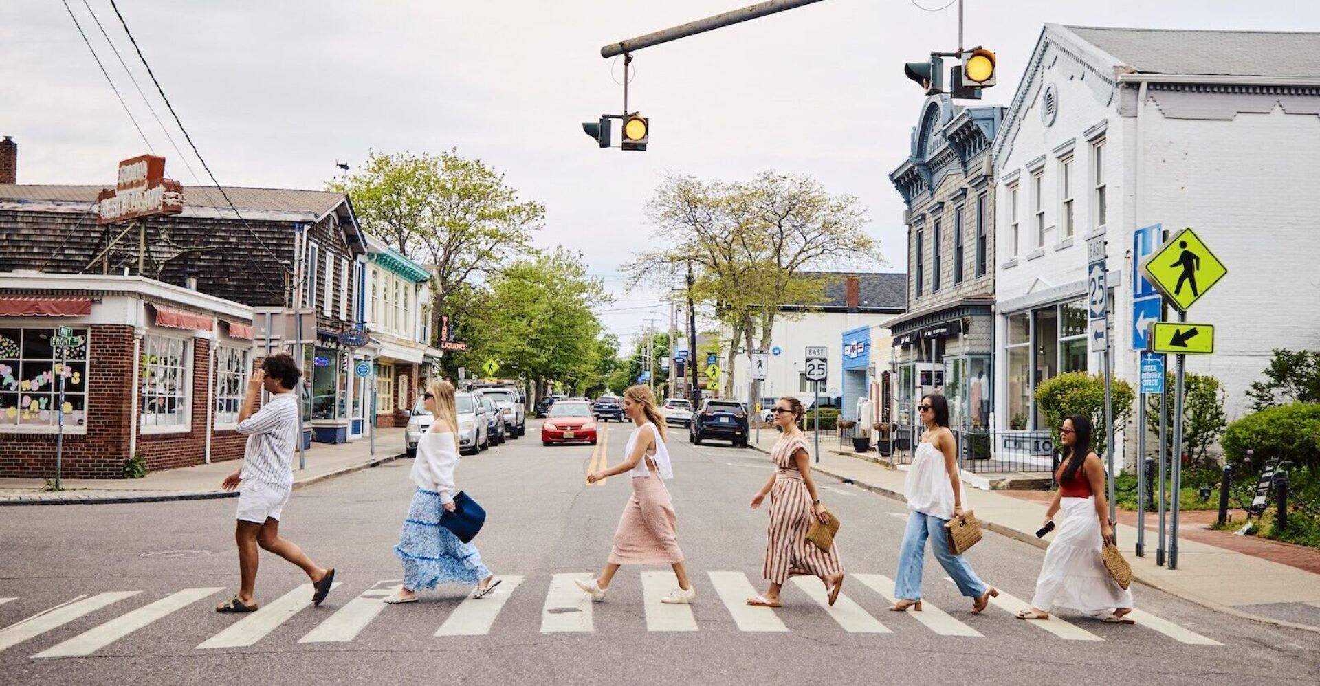 A group of friends walking across the street.