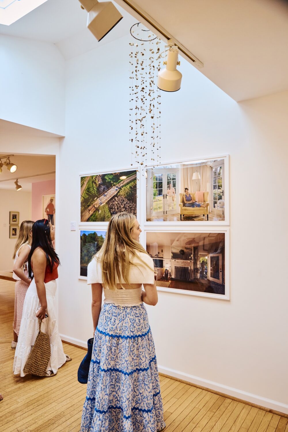Women walking around in a gallery.