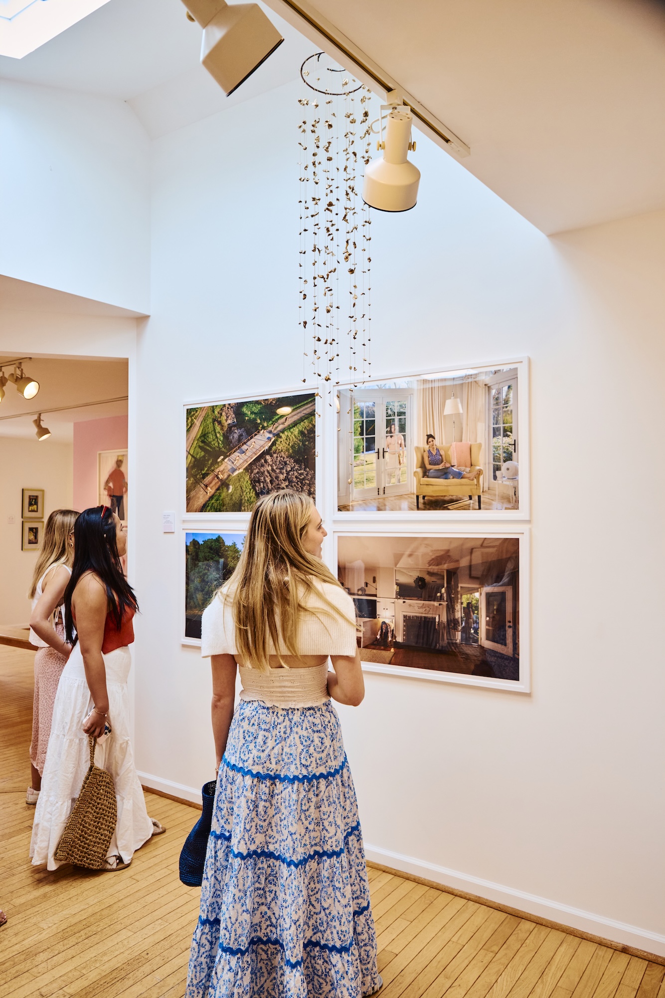 Women walking around in a gallery.