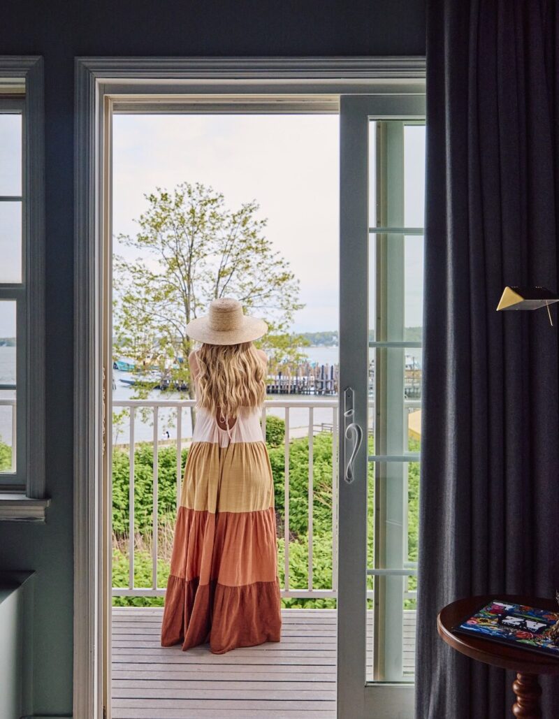 A woman looking at at the harbor on a patio.