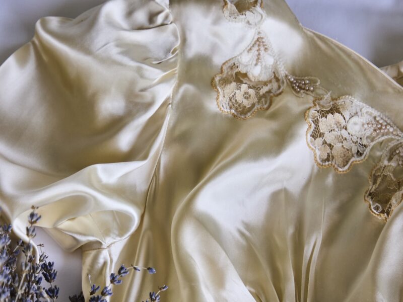 A vintage wedding dress with a bouquet of lavender.