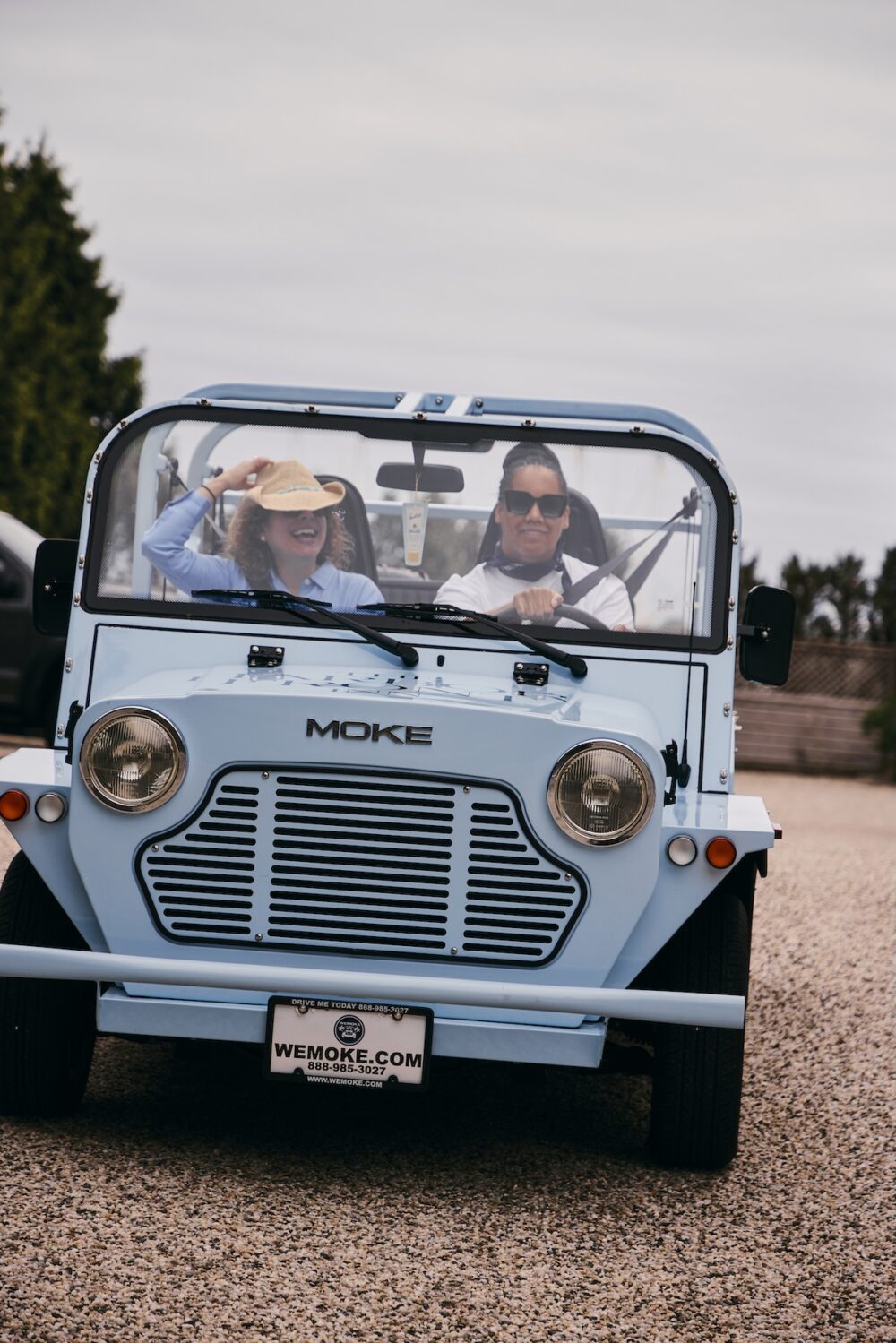 Two women riding in a Moke in Greenport, NY.