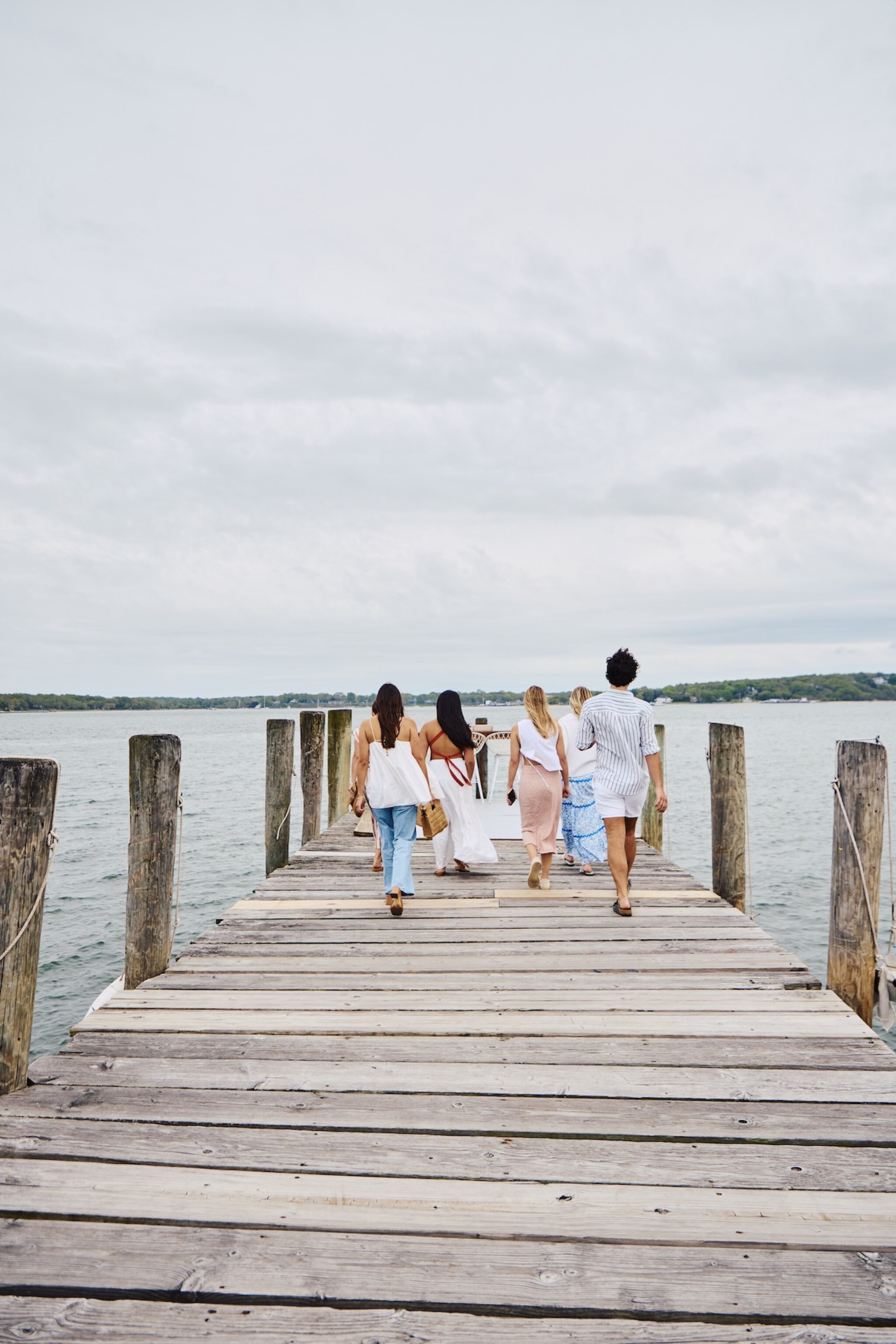 Friends walking down the pier in Greenport, New York.