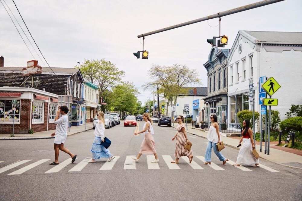 A group of friends walking across the street.