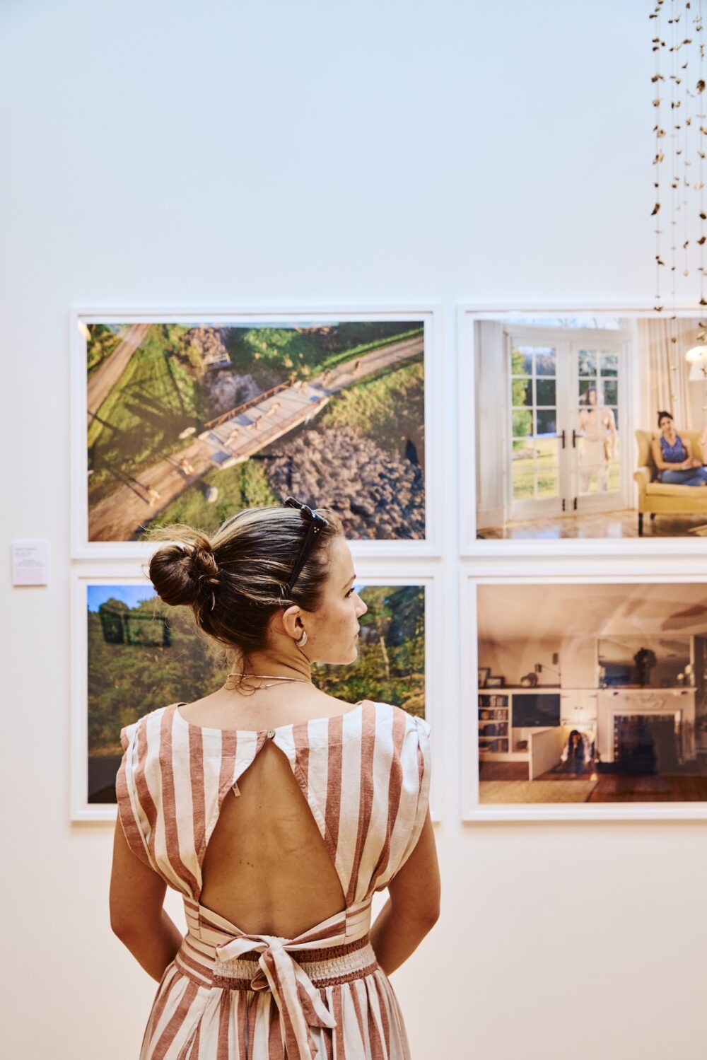 A woman looking at artwork in a gallery in North Fork.