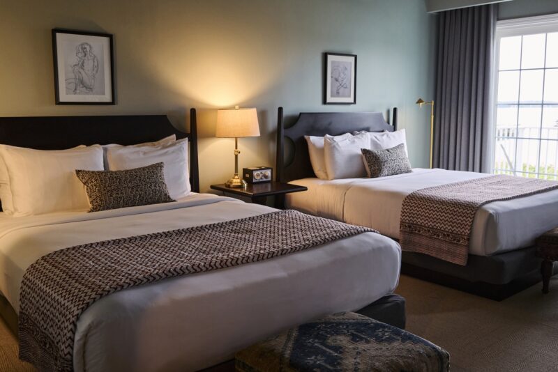 A guest bedroom at The Harbor Front Inn with two queen beds.