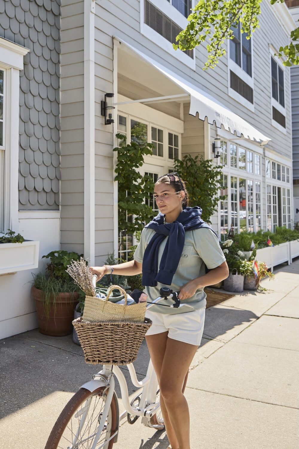A woman on a cruiser bike outside of The Harbor Front Inn.
