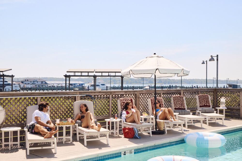 People lounging by the pool at The Harbor Front Inn.