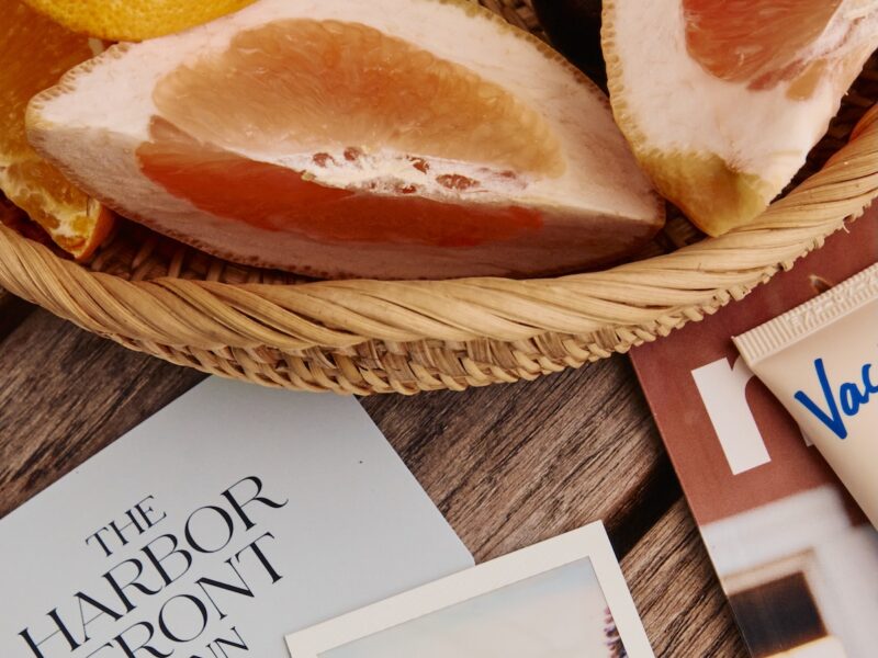 Assorted photos, room keys, fruit plate, and sunscreen.