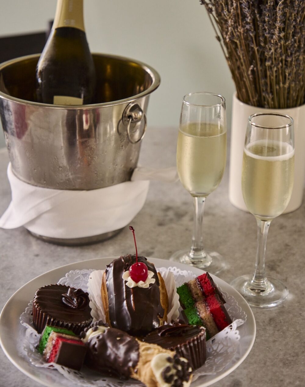 Glasses of champagne with pastries, and bucket of wine.