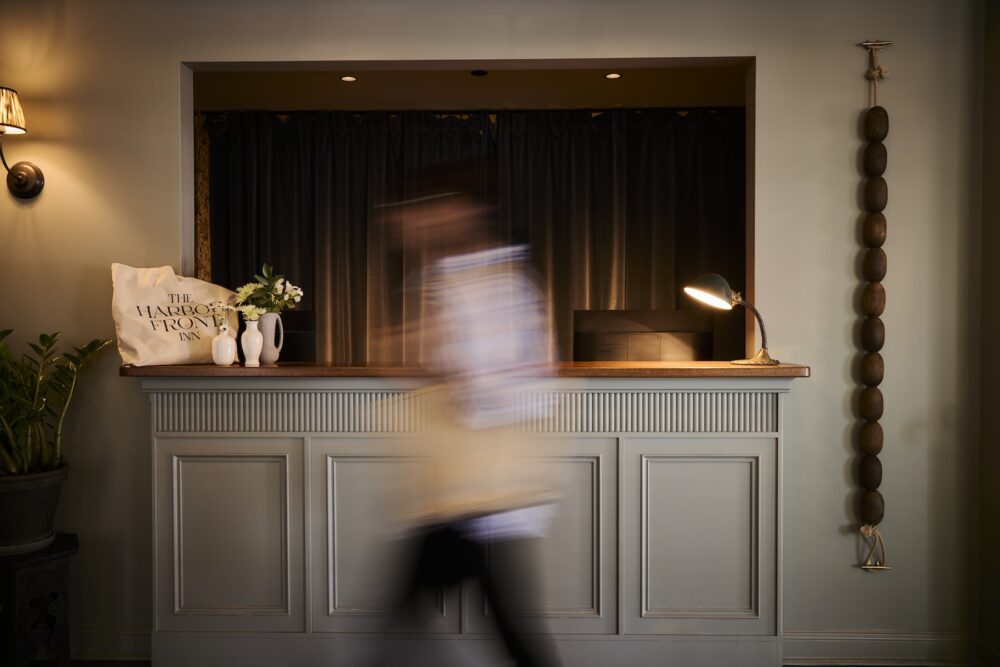 A person walking past the reception desk.