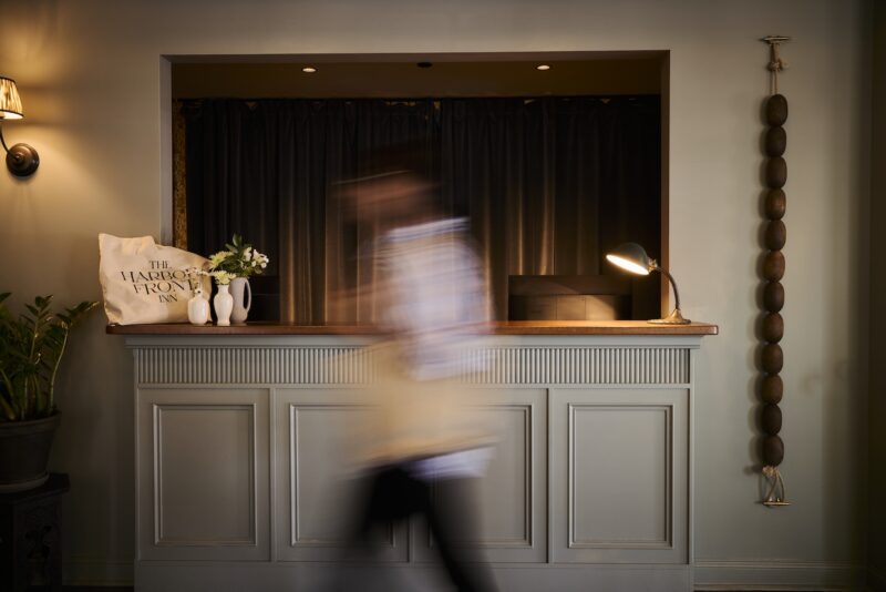 A person walking past the reception desk.