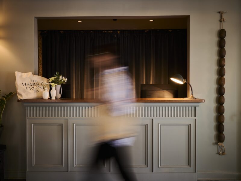 A person walking past the reception desk.