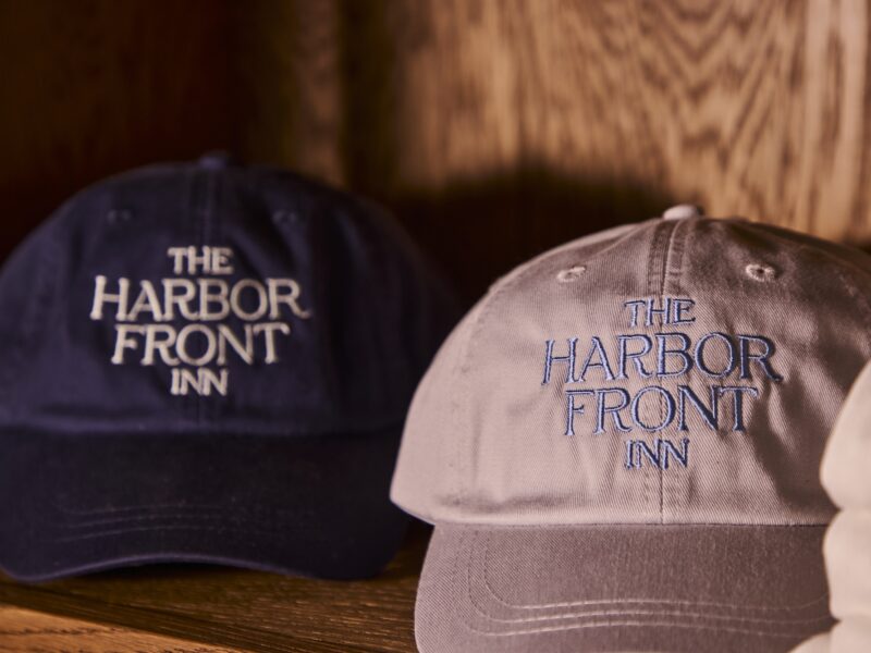 Baseball hats with The Harbor Front Inn logo.