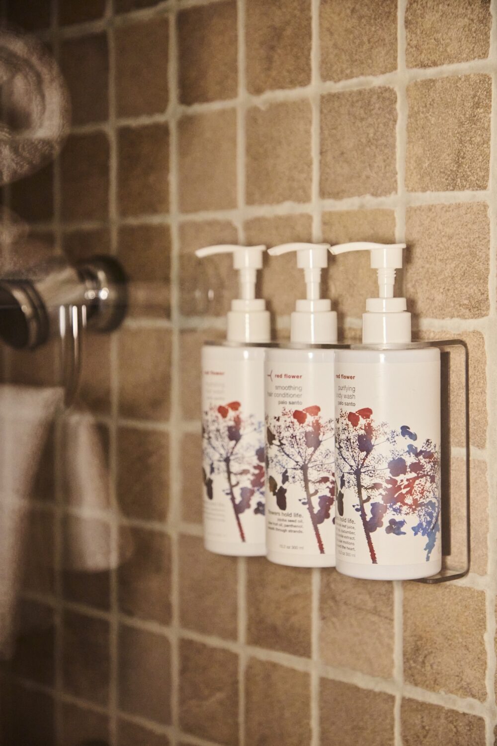 A lineup of Red Flower amenities in the shower at The Harbor Front Inn.
